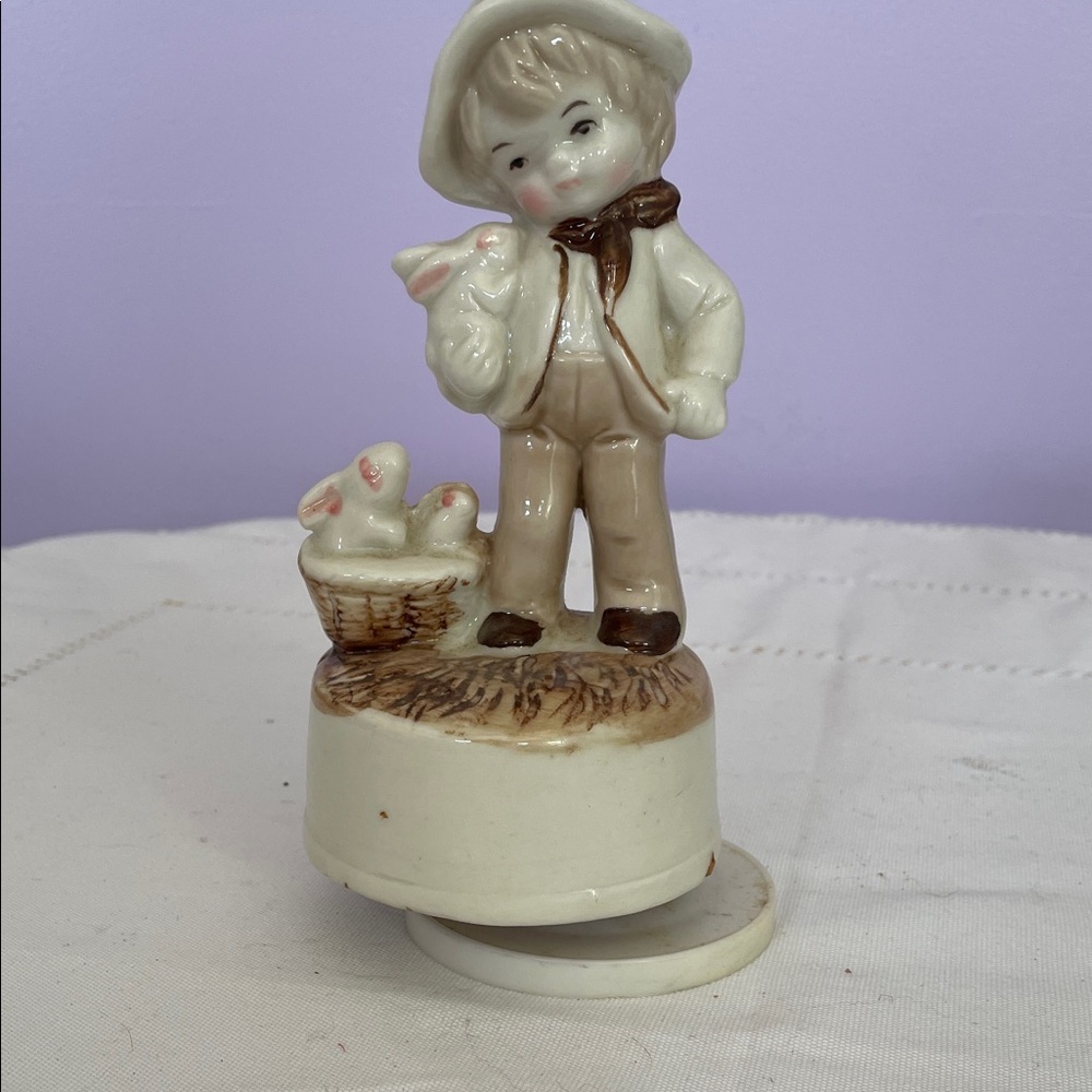 Charming Porcelain Figurine music box of a boy with Basket and bunny